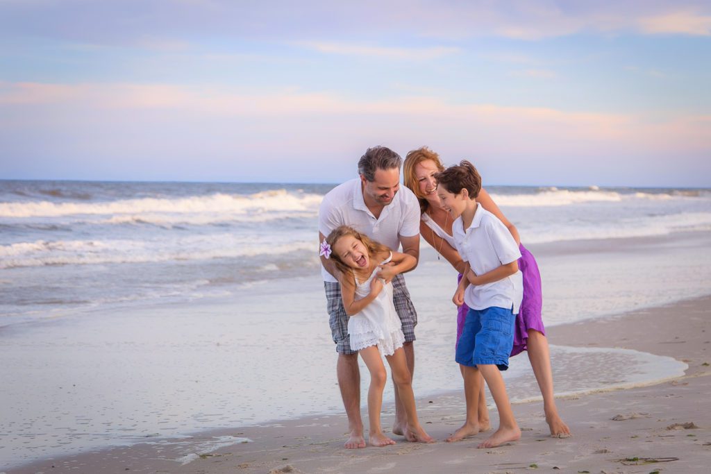 Photo of family on beach during sunset by New Jersey Newborn & Family Photographer Alyssa Joy