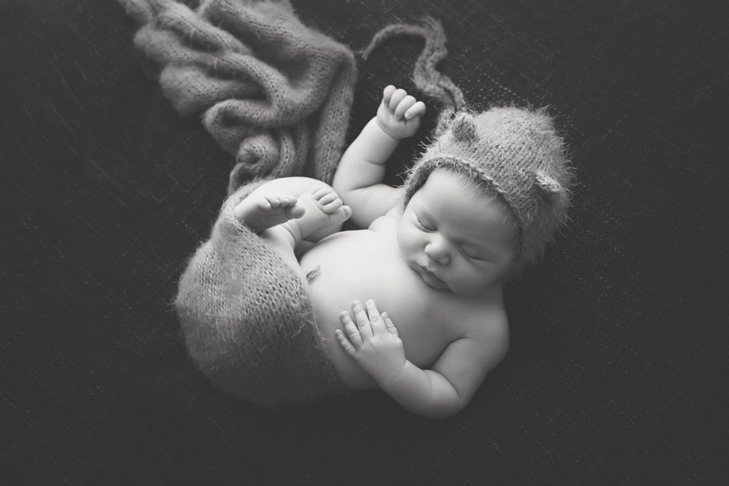black and white photo of newborn baby simply posed