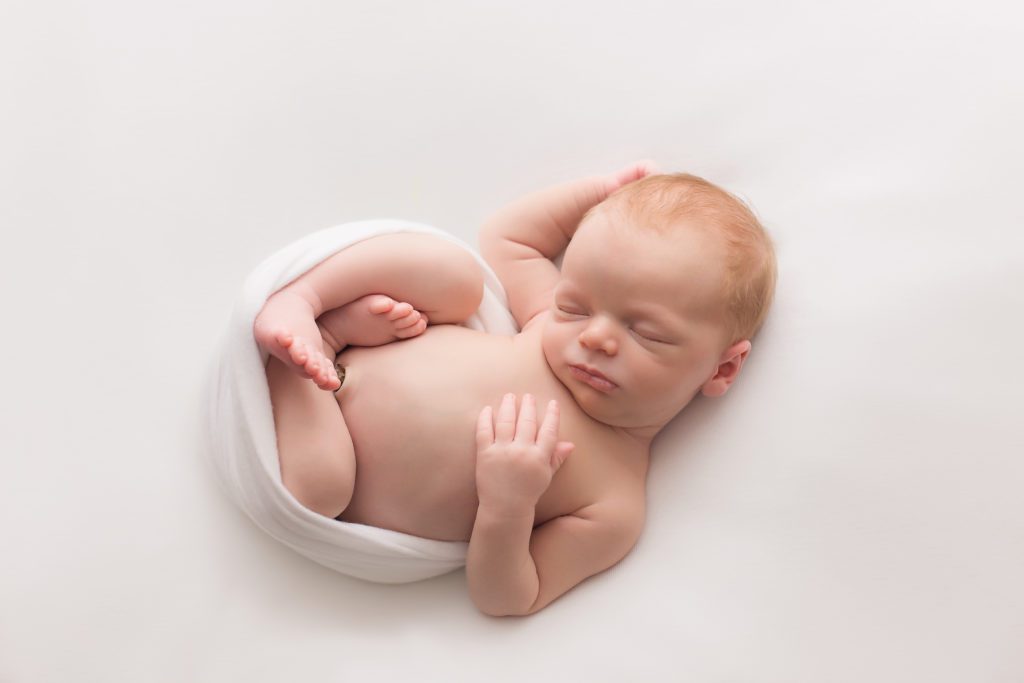 newborn baby boy simply posed on white Alyssa Joy Photography