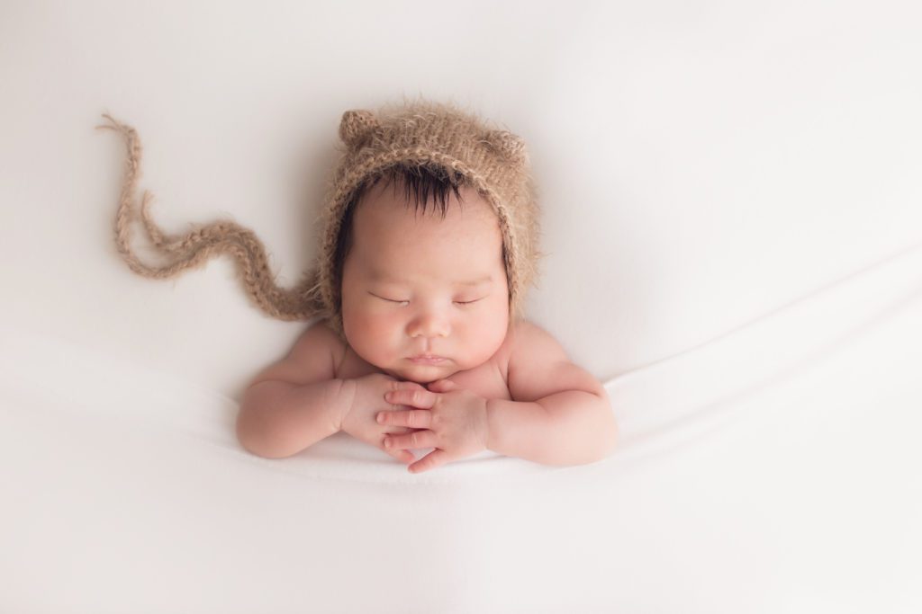 newborn baby boy wearing bear bonnet Alyssa Joy Photography