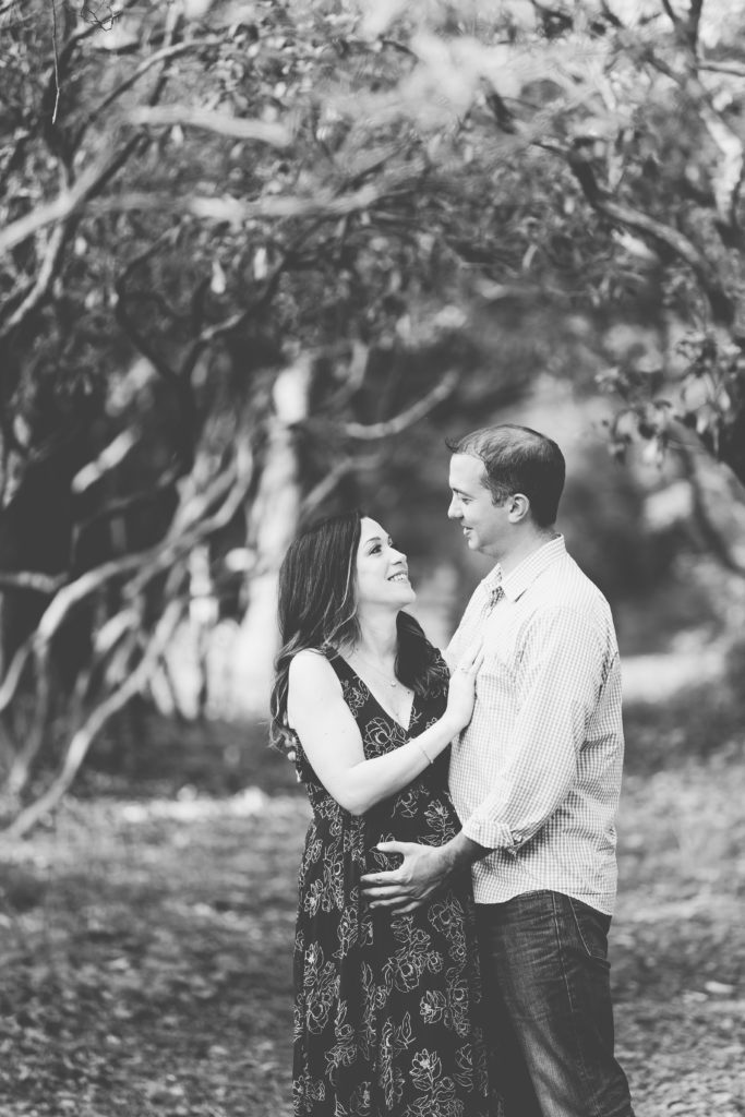black and white maternity session portrait of new parents to be outdoors in New Jersey
