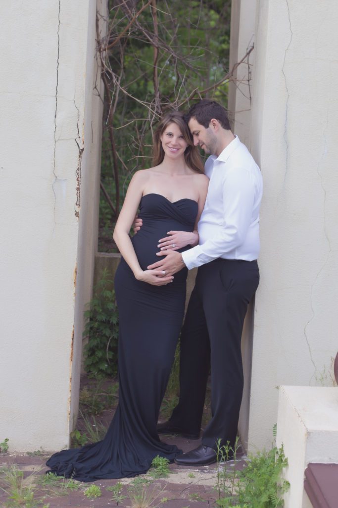 image of parents to be posing for maternity session in black dress Alyssa Joy Photography