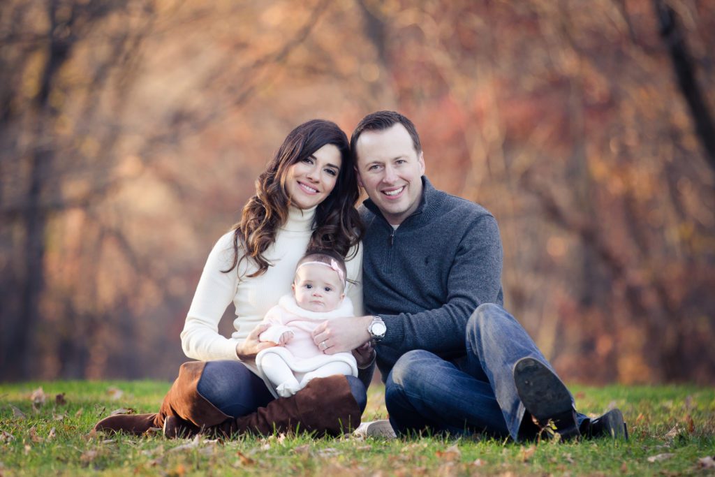 gorgeous couple with their 6 month old baby girl at family portrait session in New Jersey