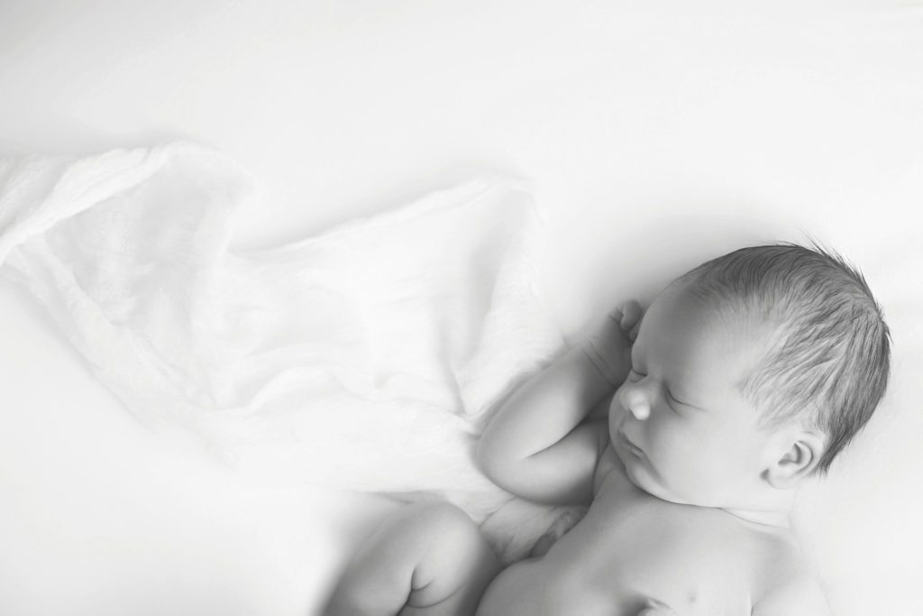 side laying newborn baby boy naturally posed by Alyssa Joy Photography