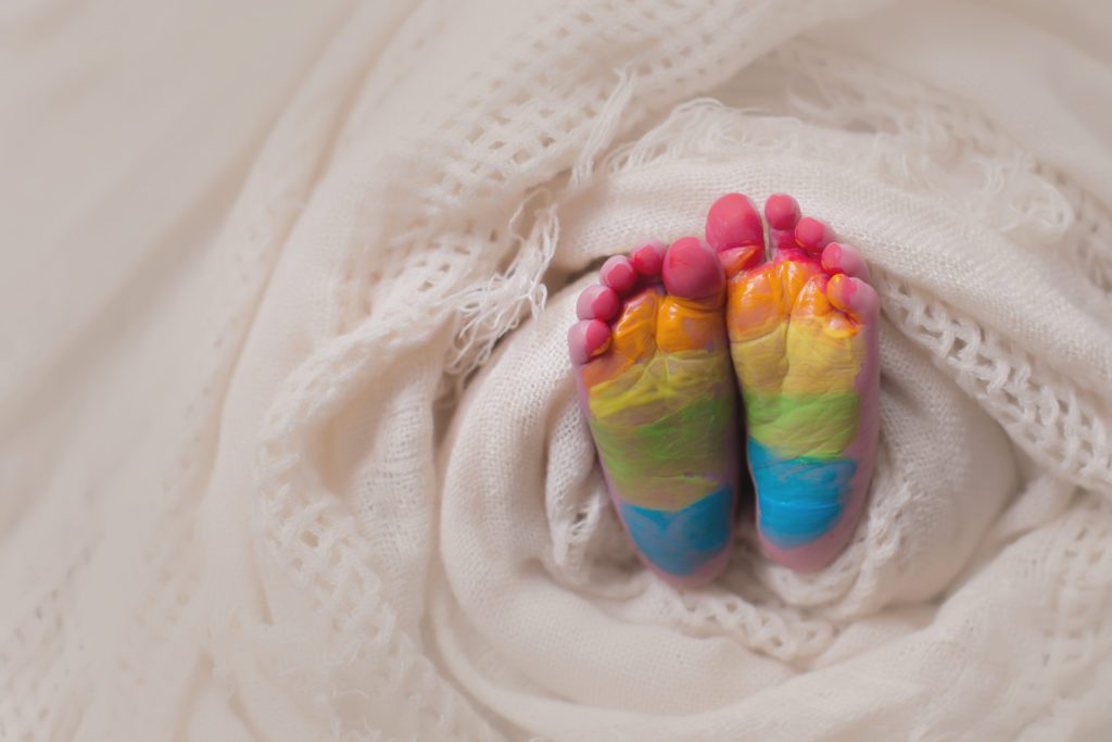 photo of rainbow baby's feet painted in rainbow colors by Alyssa Joy Photography