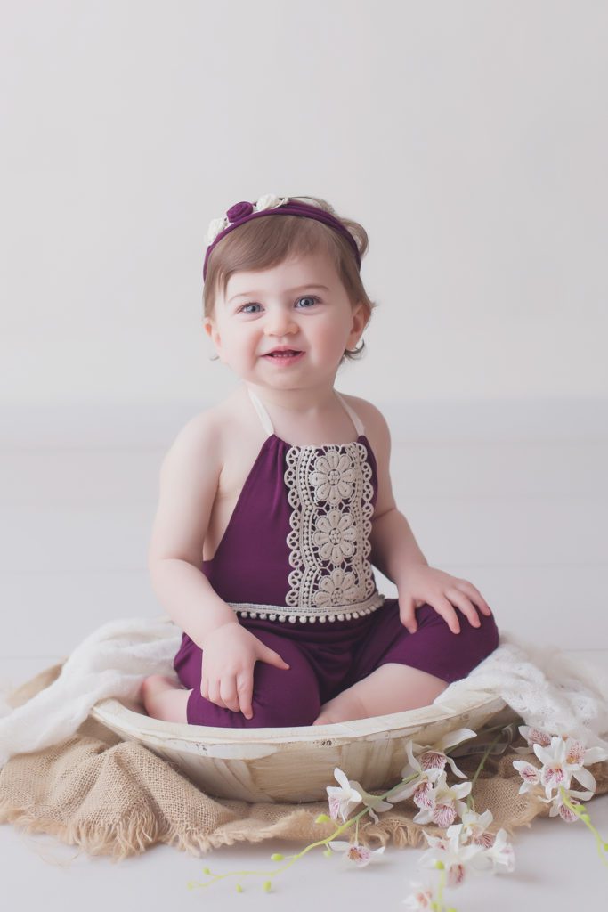 smiling one year old baby girl in handmade outfit by Alyssa Joy Photography