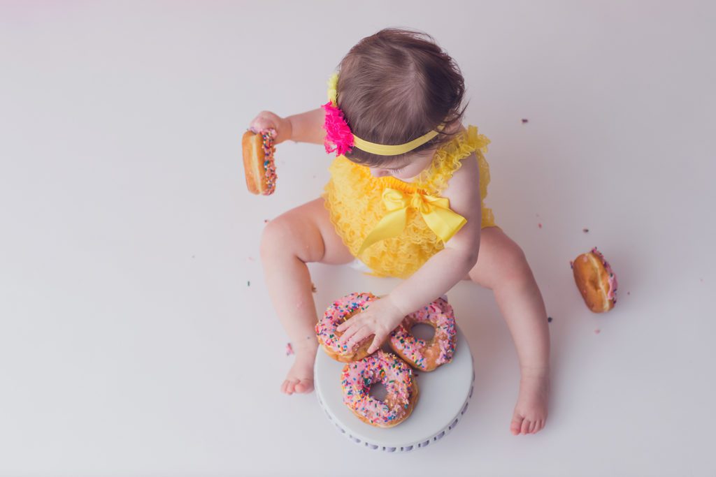 donut cake smash one year old photo session baby girl