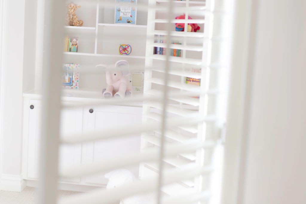 photo of nursery through shutters in newborn lifestyle photo session