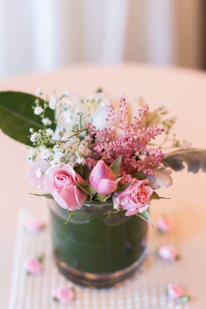 photograph of cocktail hour centerpiece fresh flowers and greenery