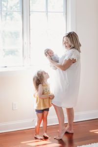 newborn lifestyle photo session natural light mom with newborn and big sister New Jersey