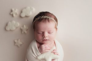 NJ newborn portraiture in studio - baby in cream colored blanket