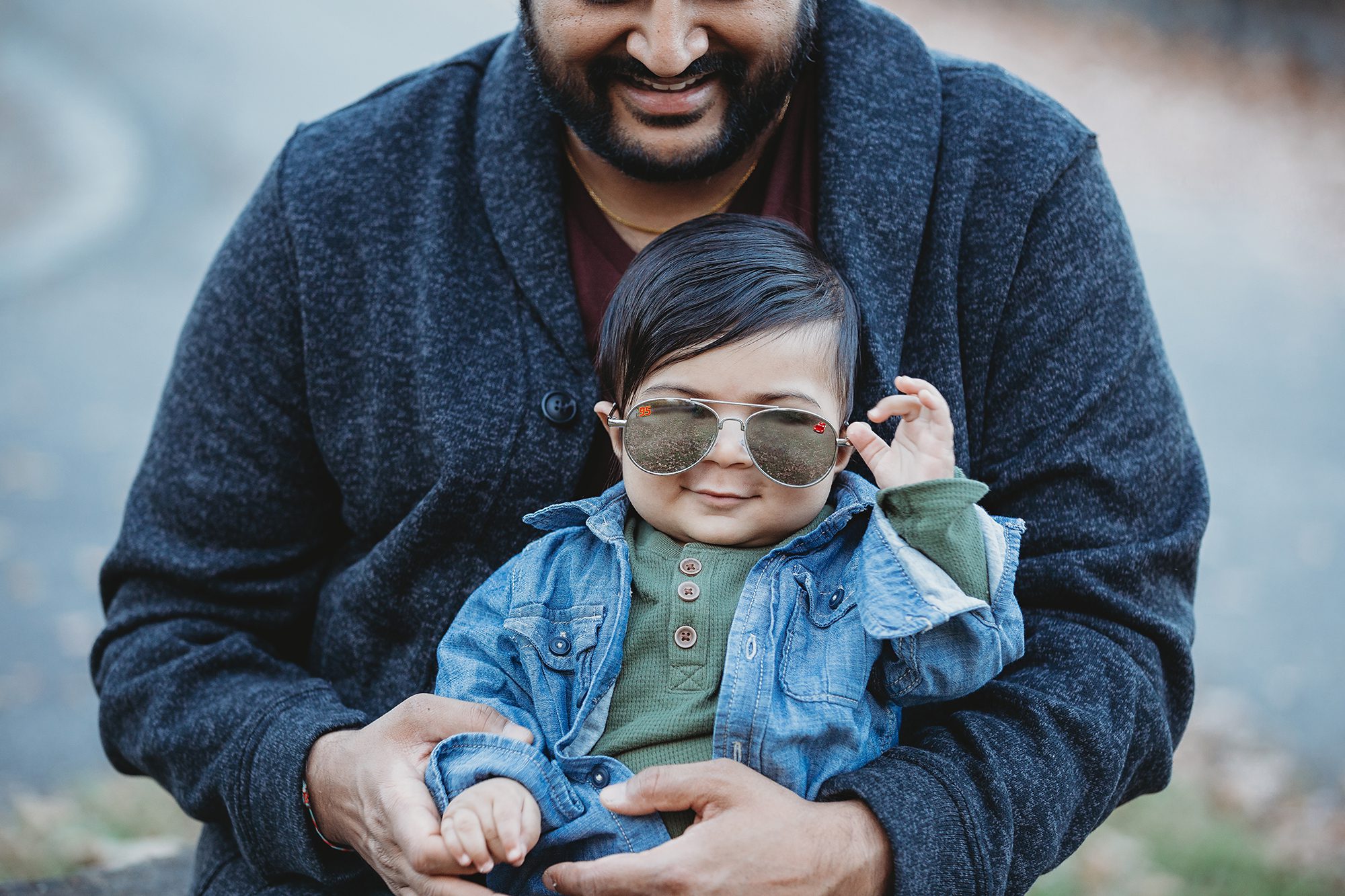 baby boy with sunglasses sitting on dad's lap fall portrait NJ
