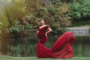 outdoor maternity photoshoot mom to be in red dress New Jersey